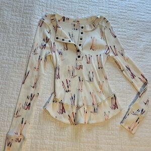 Free people movement women’s cream T-shirt w/ ski pattern, medium. Never worn.